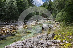 Amazing wild water in mala korita Soce valley, small pure clear turquoise flowing stream through stone gorge