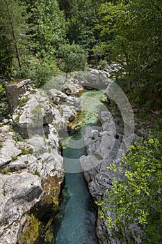 Amazing wild water in mala korita Soce valley, small pure clear turquoise flowing stream through stone gorge