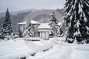 Amazing winter landscape with softly falling snow in a monastery courtyard