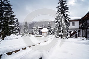 Amazing winter landscape with softly falling snow in a monastery courtyard