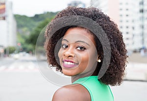 Amazing woman from Africa in a green shirt in city