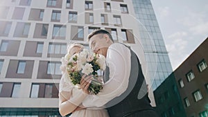 Amazing young beautiful couple. The guy and the girl are embracing each other against the backdrop of beautiful buildings. The gir