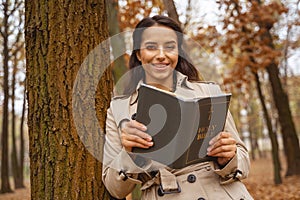 Positive delighted young woman looking at camera