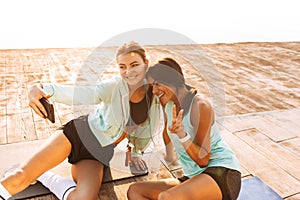 Amazing young sports woman showing peace gesture.