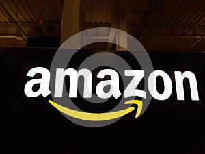 Amazon logo on black shiny wall in Honolulu Best Buy store