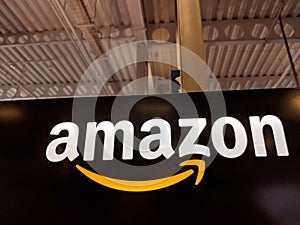 Amazon logo on black shiny wall in Honolulu Best Buy store