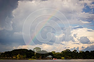Amazon river jungle rainbow and clouds