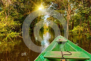 Amazon river, Manaus, Amazonas, Brazil: Wooden boat floating on the Amazon river in the backwaters of the Amazon jungle
