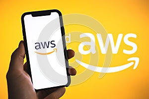 Amazon Web Services logo on the smartphone screen.