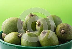 Ambarella or june plum, edible fruit in a bowl photo