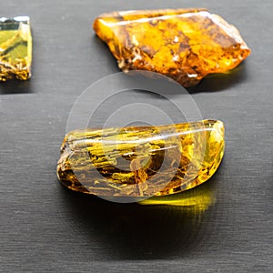 Amber on a black background. Beautiful colored pieces of amber. Amber texture.