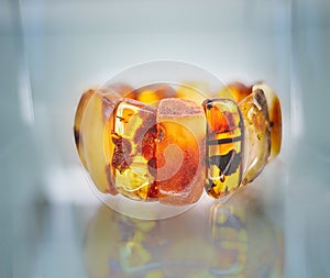 Amber bracelet on a glass shelf