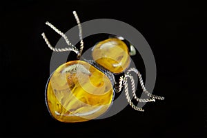 Amber brooch on a black background