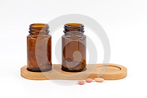 Amber glass bottles for cosmetics, natural medicine and other medicines, filled with pills and capsules, vitamins D and E, fish