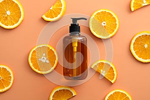 Amber glass pump bottle with natural shampoo with Vitaminc C and sliced orange top view