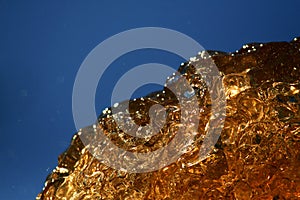 Abstract background with amber color water, sunlight, blue sky photo