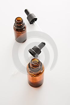 Amber mini bottles mockups with pipettes. photo