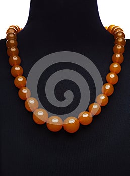 Amber necklace on black mannequin