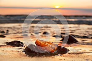 Amber stone on the beach. Precious gem, treasure. Baltic Sea