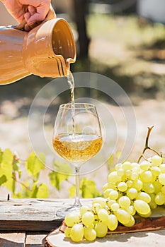 Amber wine in glasses on the nature: still life with cheese, grapes and wine in a rustic style. Georgian national wine or italian