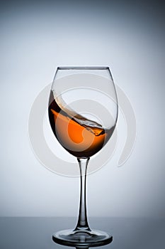 Amber wine. A splash of wine in a glass.