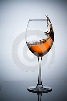 Amber wine. A splash of wine in a glass.