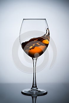 Amber wine. A splash of wine in a glass.