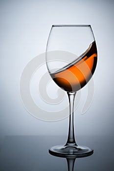 Amber wine. A splash of wine in a glass.