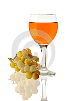 Amber wine. Wine in a glass and a handful of white grapes.