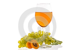 Amber wine. Wine in a glass near fruits and grapes.