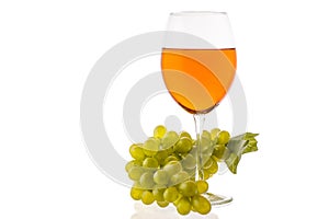 Amber wine. Wine in a glass near grapes.