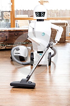 Ambient assisted living roboter is vacuuming