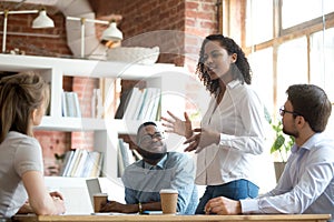 Ambitious african black female employee speaking at diverse meeting