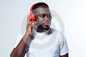 An ambitious african listening to music and wearing cool glasses