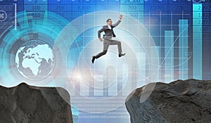 The ambitious businessman jumping over the cliff