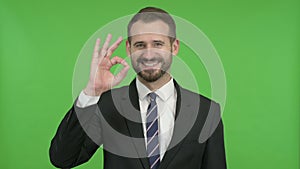 Ambitious Businessman Showing OK Sign against Chroma Key