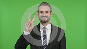 The Ambitious Businessman Showing Victory Sign against Chroma Key