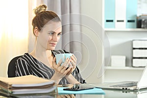 Ambitious businesswoman looks away at office