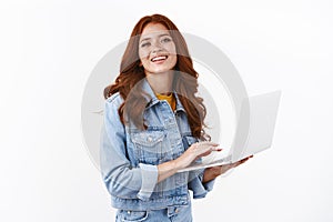 Ambitious enthusiastic good-looking girl lead van-life, working remote, standing over white background stylish denim