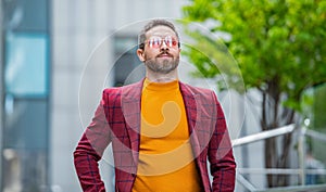 ambitious guy in menswear outdoor. guy in menswear in the street. guy in menswear outside.