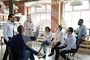 Male worker raise hand asking question at office teambuilding photo