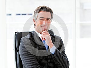 Ambitious male executive sitting in his office photo