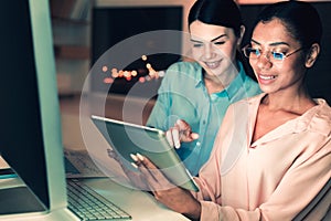 Ingenious interns sitting with tablet