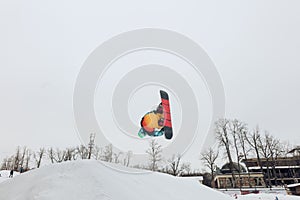 Ambitious talented snowboarder performing a jump