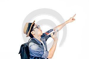 Ambitious young tourist pointing up to the sky dreaming to travel isolated over white background