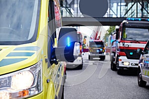 Ambulance car, fire engines and a police car.