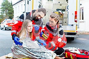 Ambulance doctor helping injured woman