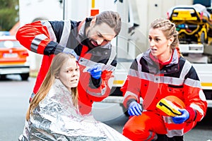 Ambulance doctor helping injured woman