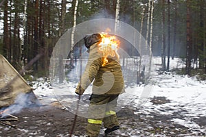 Ambulance drills in the winter forest. The woman stuntman caught fire from the fire and flees. Rescuers will have to