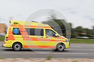 The ambulance is driving on the street at high speed. Motion blur